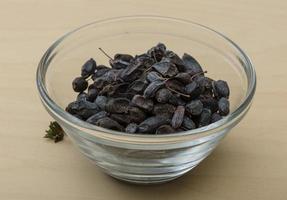 Barberries in a bowl on wooden background photo