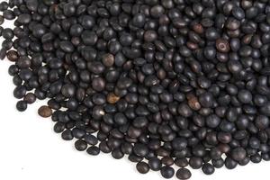 Heap of black lentil isolated on white photo