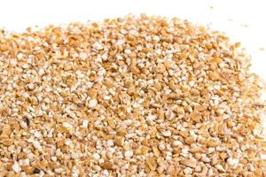 Pearl barley heap isolated on white photo