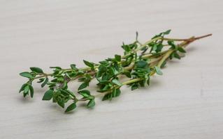 Thyme on wooden background photo