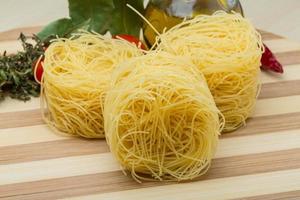 Round vermicelli on wooden board and wooden background photo