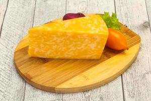 Marble cheese  triangle over wooden photo