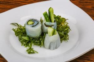 Squid sashimi on the plate and wooden background photo