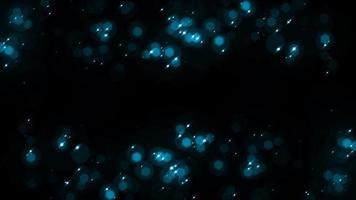 Schleife blauer Stern sprudelt Partikel, die auf schwarzem abstrakten Hintergrund schweben. video