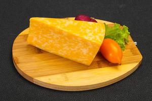 Marble cheese  triangle over wooden photo