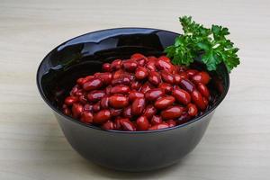 Baked beans in a bowl on wooden background photo