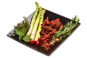 Dried tomato with asparagus and herbs photo