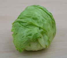 Iceberg salad on wooden background photo