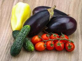 Fresh vegetables on wooden background photo