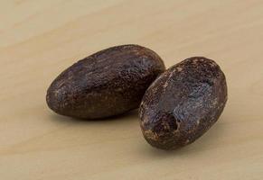 Nutmeg on wooden background photo