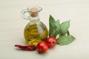 Olive oil on wooden background photo