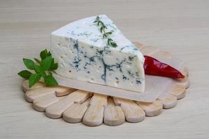 Blue cheese on wooden board and wooden background photo