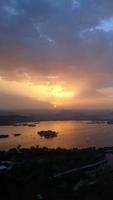 Evening view of Udaipur city skyline and lake Pichola vertical time lapse video seen from Udaipur view point.