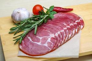 Sliced Ham on wooden board and wooden background photo