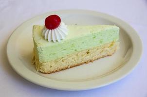 Pistachio cheesecake on the plate and white background photo