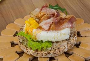 Crispy sandwich with egg and bacon photo