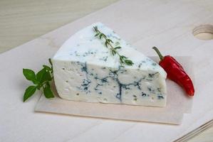 Blue cheese on wooden board and wooden background photo