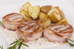 Grilled steak wrapped in bacon, with grilled vegetables, mashed potatoes photo