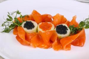 Sliced salmon with caviar photo