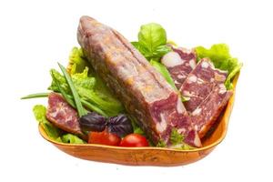 Ripe salami with salad, basil, onion and tomato photo