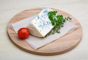 Blue cheese on wooden board and wooden background photo