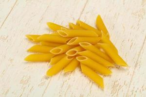 Raw penne pasta for bowl photo