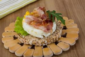 Crispy sandwich with egg and bacon photo