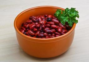 Baked beans in a bowl on wooden background photo