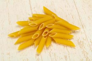 Raw penne pasta for bowl photo