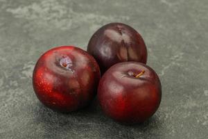 Ripe sweet plum fruit heap photo