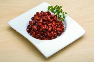 Baked beans in a bowl on wooden background photo