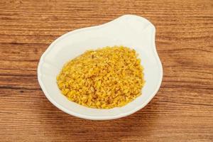 Vegetarian cuisine - dry bulgur for cooking photo