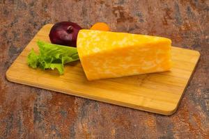 Marble cheese  triangle over wooden photo