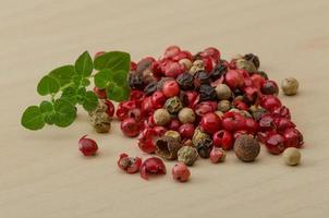 Pepper mix on wooden background photo