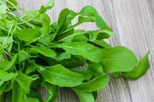Ruccola on wooden background photo