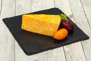 Marble cheese  triangle over wooden photo