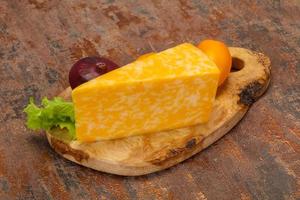 Marble cheese  triangle over wooden photo