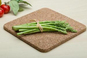 Asparagus on wooden board and wooden background photo