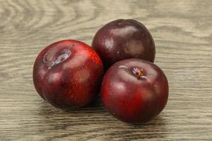 Ripe sweet plum fruit heap photo