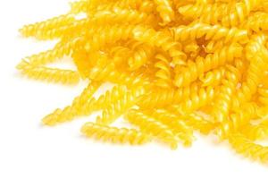 pile of fusilli pasta close up on wood background photo