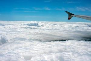 clouds in the sky from airplane window photo