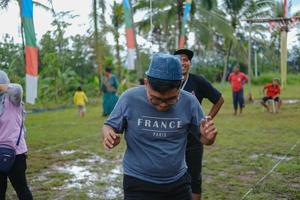 Blitar, Indonesia - September 11th 2022 Enthusiastic teenage boys take part in a competition to commemorate Indonesian Independence Day in Blitar in the aftern photo