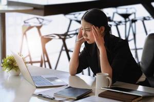 Company employees show boredom from unfinished work using computer notebook, documents and tablets at work. photo