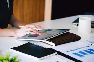 Business owners are using a computer tablet. in managing financial statements to adjust the company's financial structure. photo