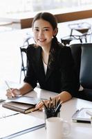 Company employees are sitting at work using tablet and documents in their work. photo