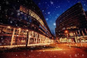 Panorama of the night city of Dusseldorf in winter during a snowstorm. Bokeh light effect, soft filter photo