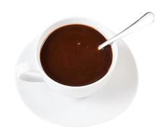 carob powder drink in white cup with spoon photo