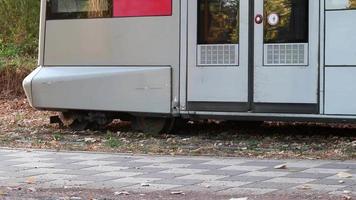 Public transportation tramway with open doors closing doors and leaving the train station for city travel of tourists and commuters to work and back home to reduce co2 emissions with electric trains video