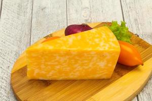 Marble cheese  triangle over wooden photo