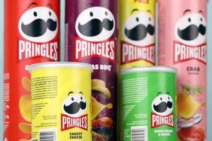 KHARKIV, UKRAINE - DECEMBER 16, 2021 Pringles product with new logo. Pringles is a brand of potato snack chips owned by the Kellogg Company photo